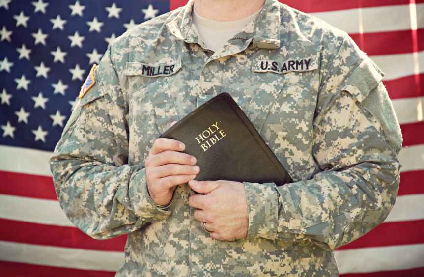 U.S. Army man holding Bible